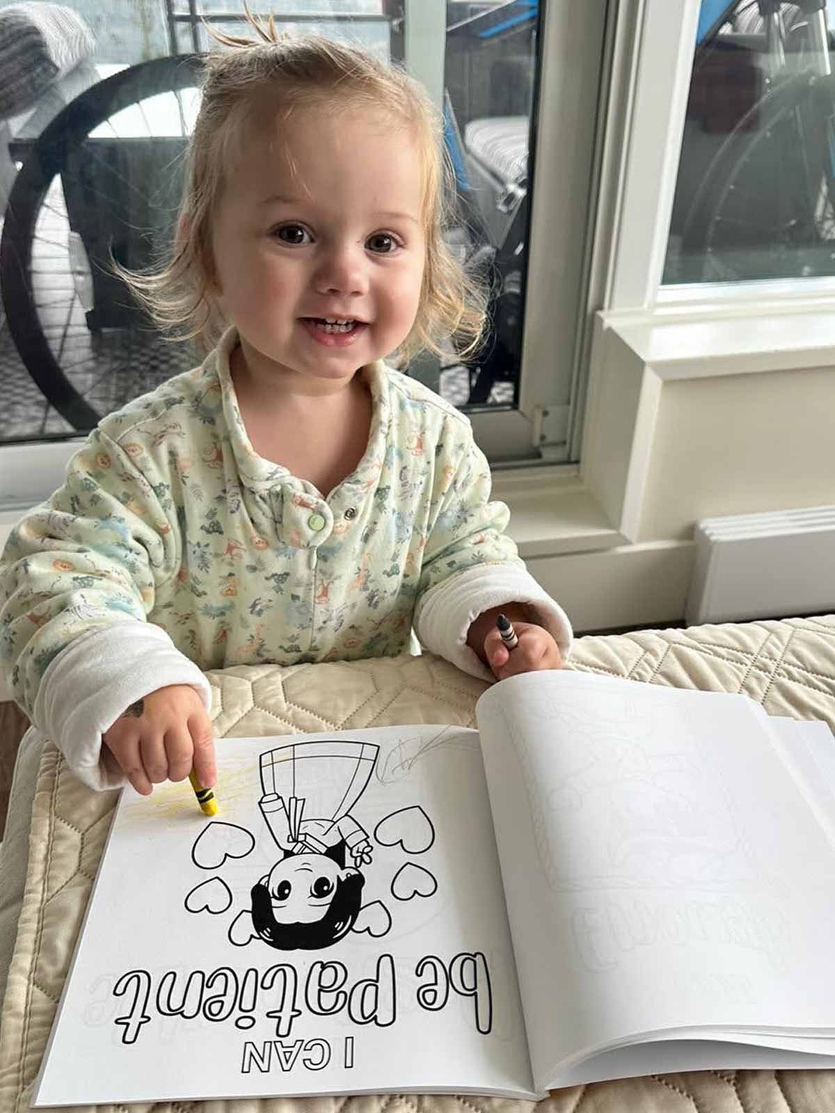 Kid coloring an inspirational page from The Joy in You coloring book
