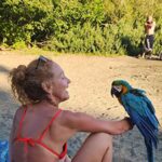 Daniela Martins with a bird at the lake.
